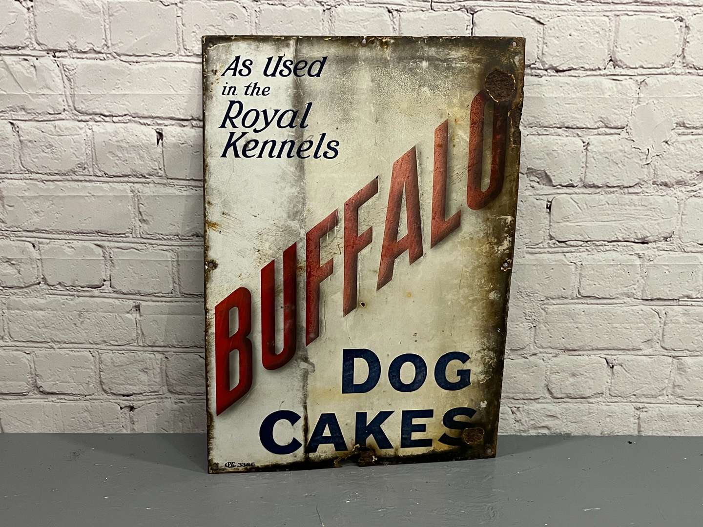 <p>Buffalo Dog Cakes “As Used In The Royal Kennels” Enamel Sign</p>