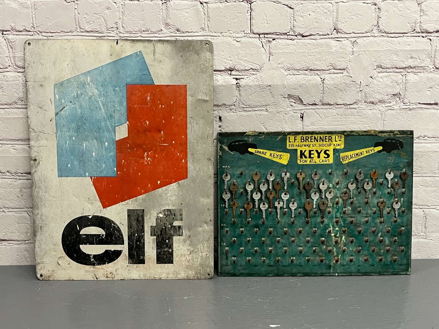 <p>Elf Oils Sign and LF Brenner Ltd Key Board</p>