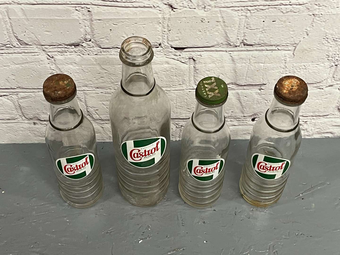 <p>Four Glass Castrol Oil Bottles&nbsp;</p>