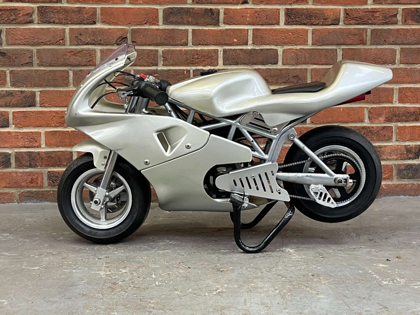 <p>Miniature 49cc Motorcycle and Stand</p>