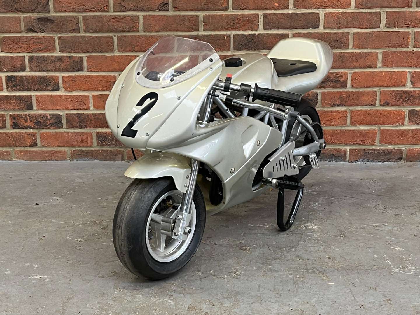 <p>Miniature 49cc Motorcycle and Stand</p>