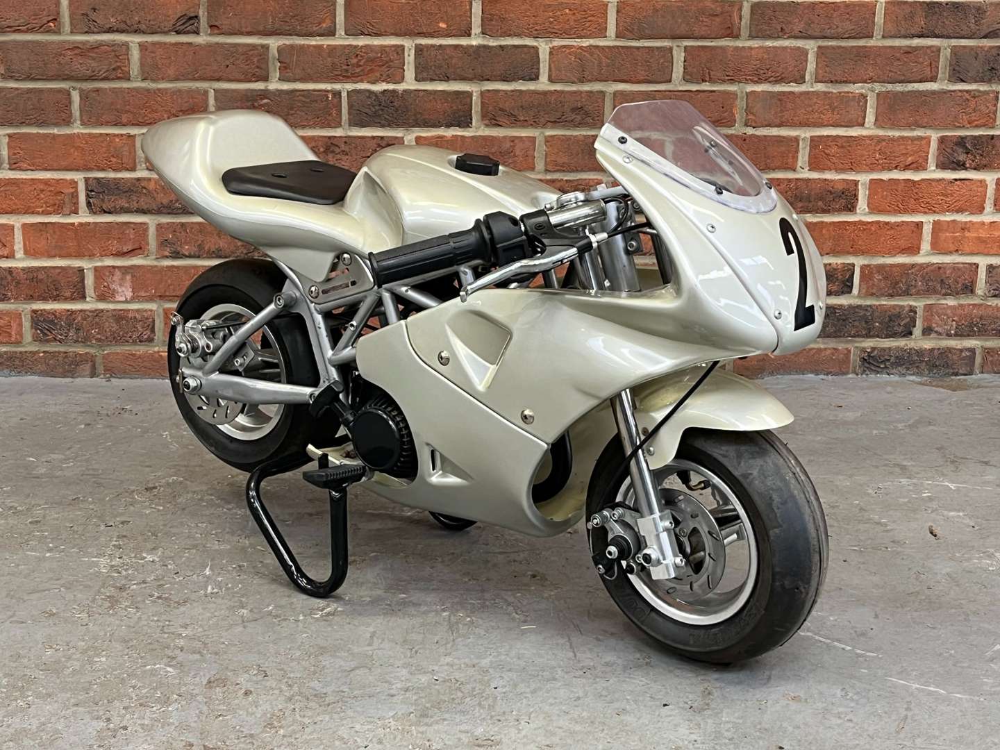 <p>Miniature 49cc Motorcycle and Stand</p>