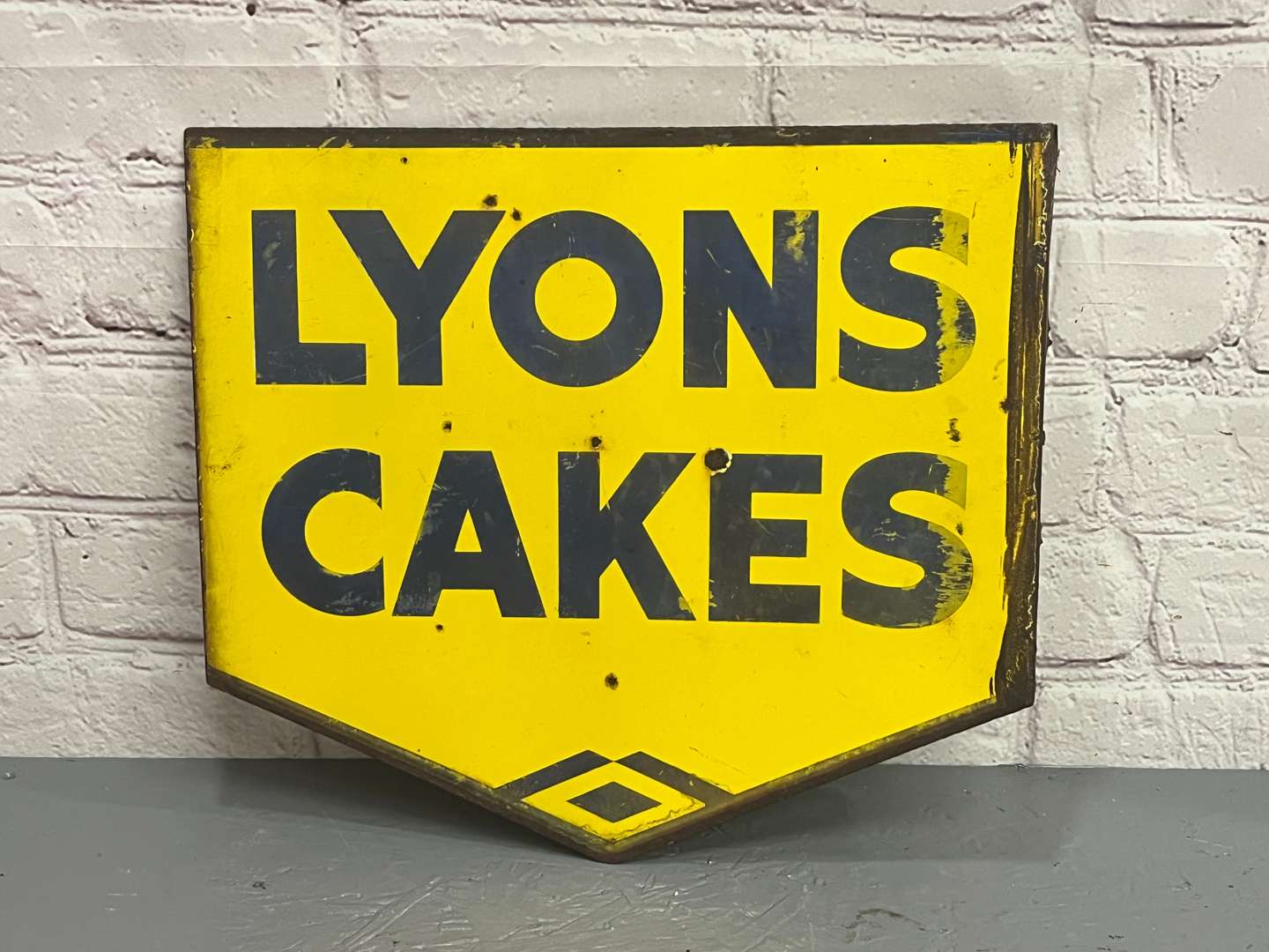 <p>Lyons Cakes Enamel Flange Sign</p>