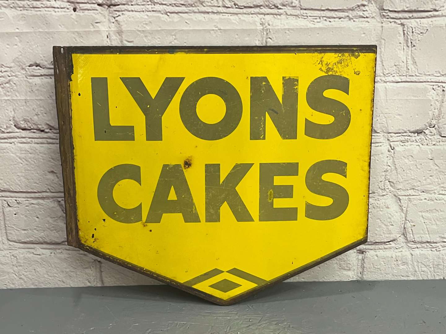 <p>Lyons Cakes Enamel Flange Sign</p>
