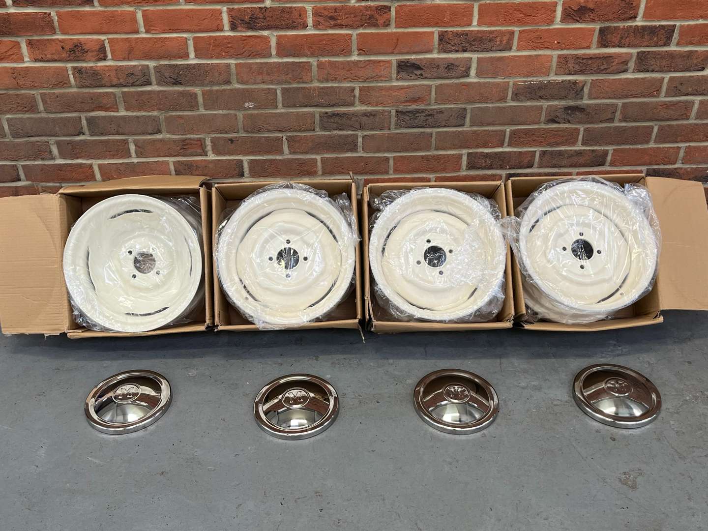 <p>Set of Four Boxed Morris Minor Wheels and Chrome Trims&nbsp;</p>