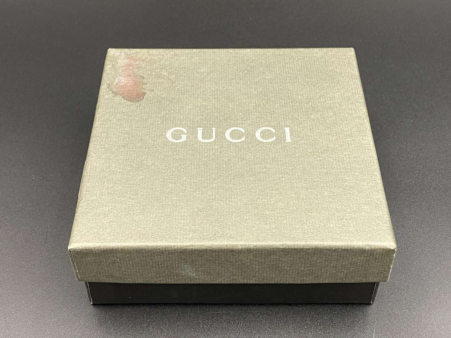 <p>GUCCI, &nbsp;a black, grained, leather wallet with signed and polished clasp</p>