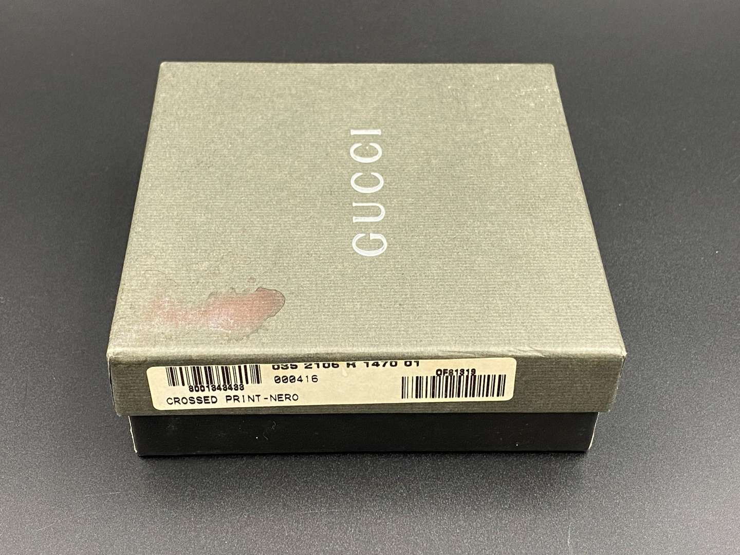 <p>GUCCI, &nbsp;a black, grained, leather wallet with signed and polished clasp</p>