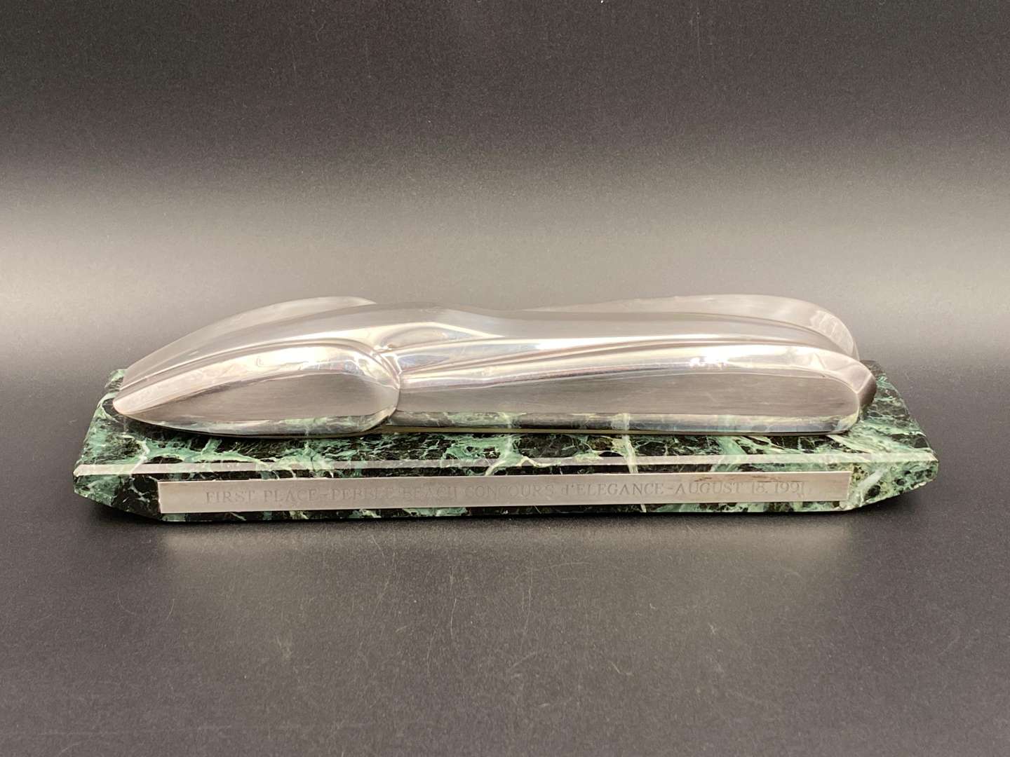 <p>"FIRST PLACE, PEBBLE BEACH CONCOURS d ELEGANCE, AUGUST 18. 1991", silver and marble trophy,&nbsp;</p>