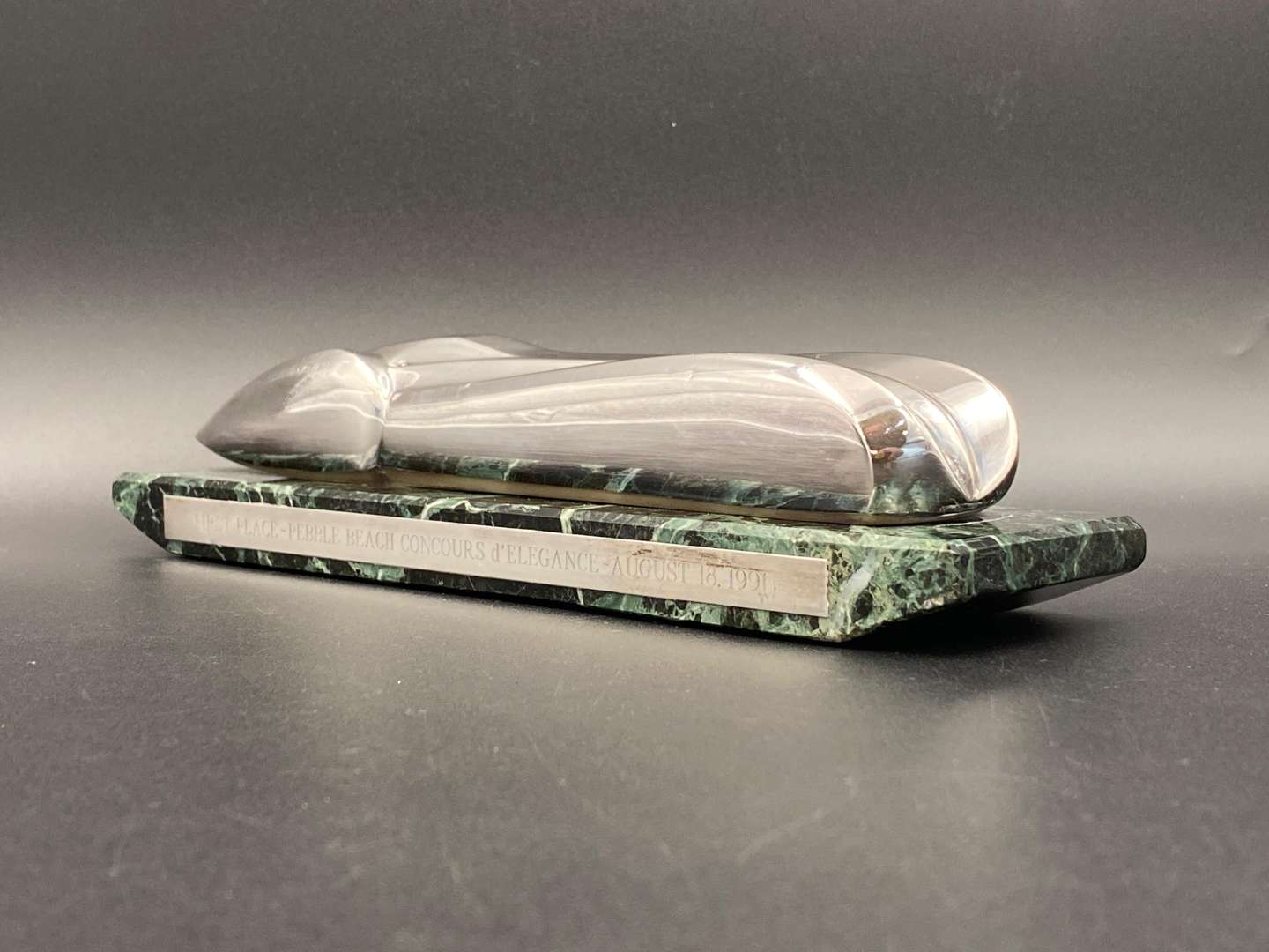 <p>"FIRST PLACE, PEBBLE BEACH CONCOURS d ELEGANCE, AUGUST 18. 1991", silver and marble trophy,&nbsp;</p>