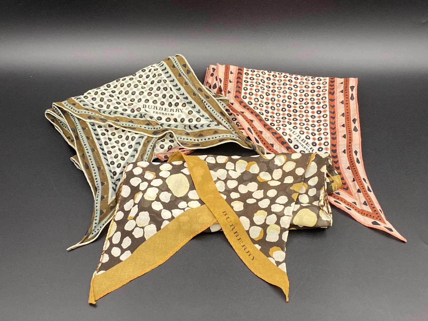 <p>BURBERRY, three various slim, neck scarves</p>