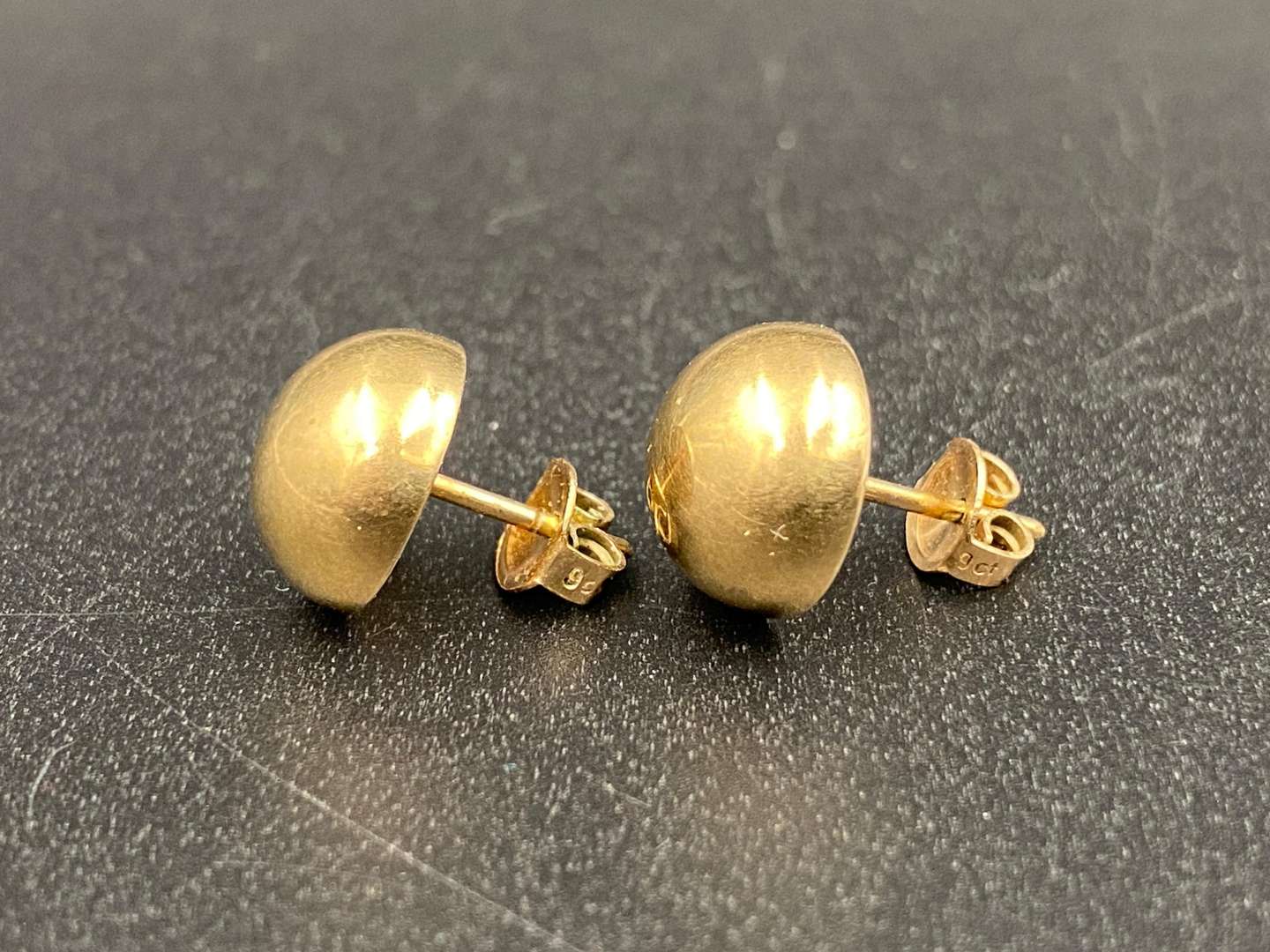 <p>Pair of unmarked, ½ round ear studs</p>