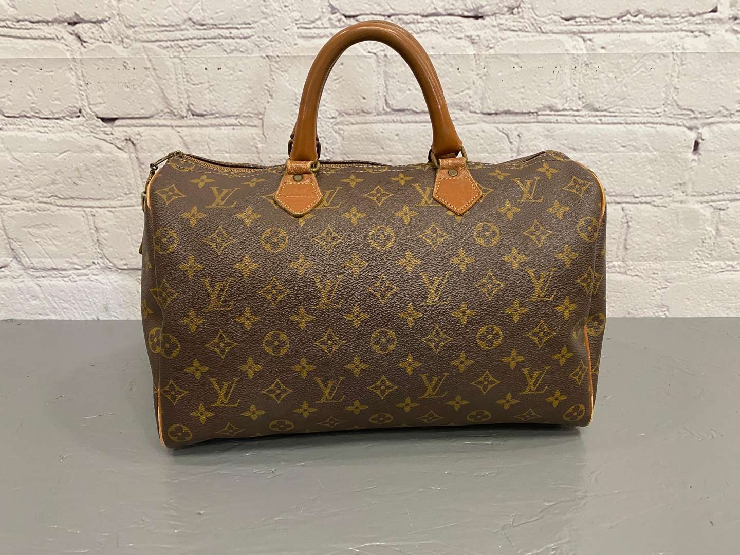 <p>LOUIS VUITTON, Speedy 35, monogram canvas and stitched leather holdall,</p>