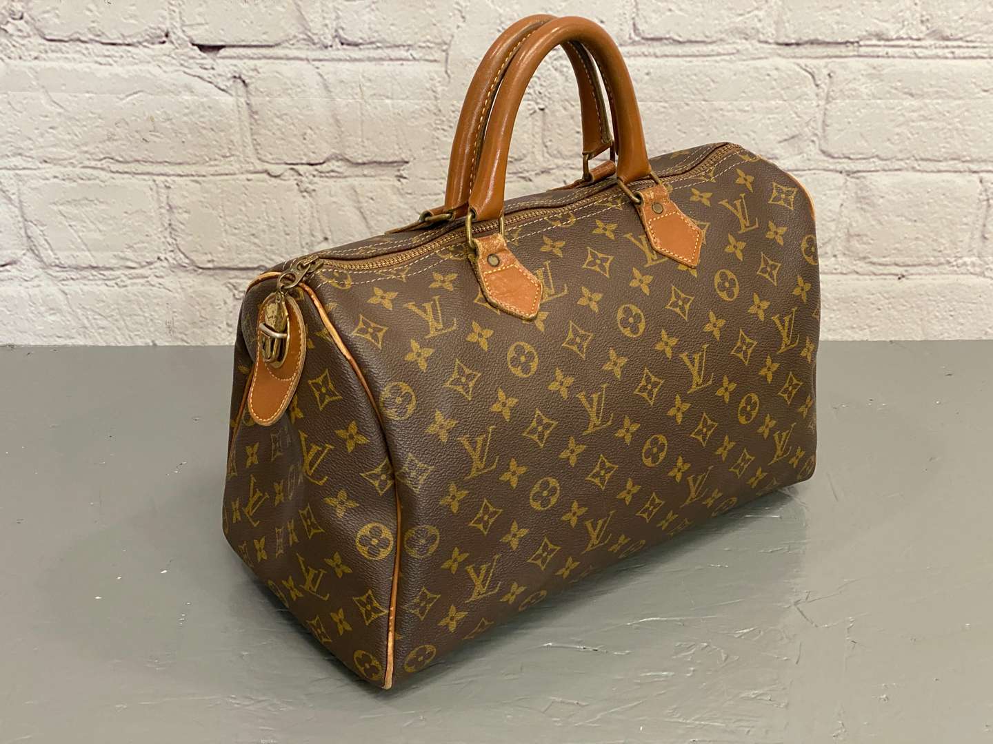 <p>LOUIS VUITTON, Speedy 35, monogram canvas and stitched leather holdall,</p>