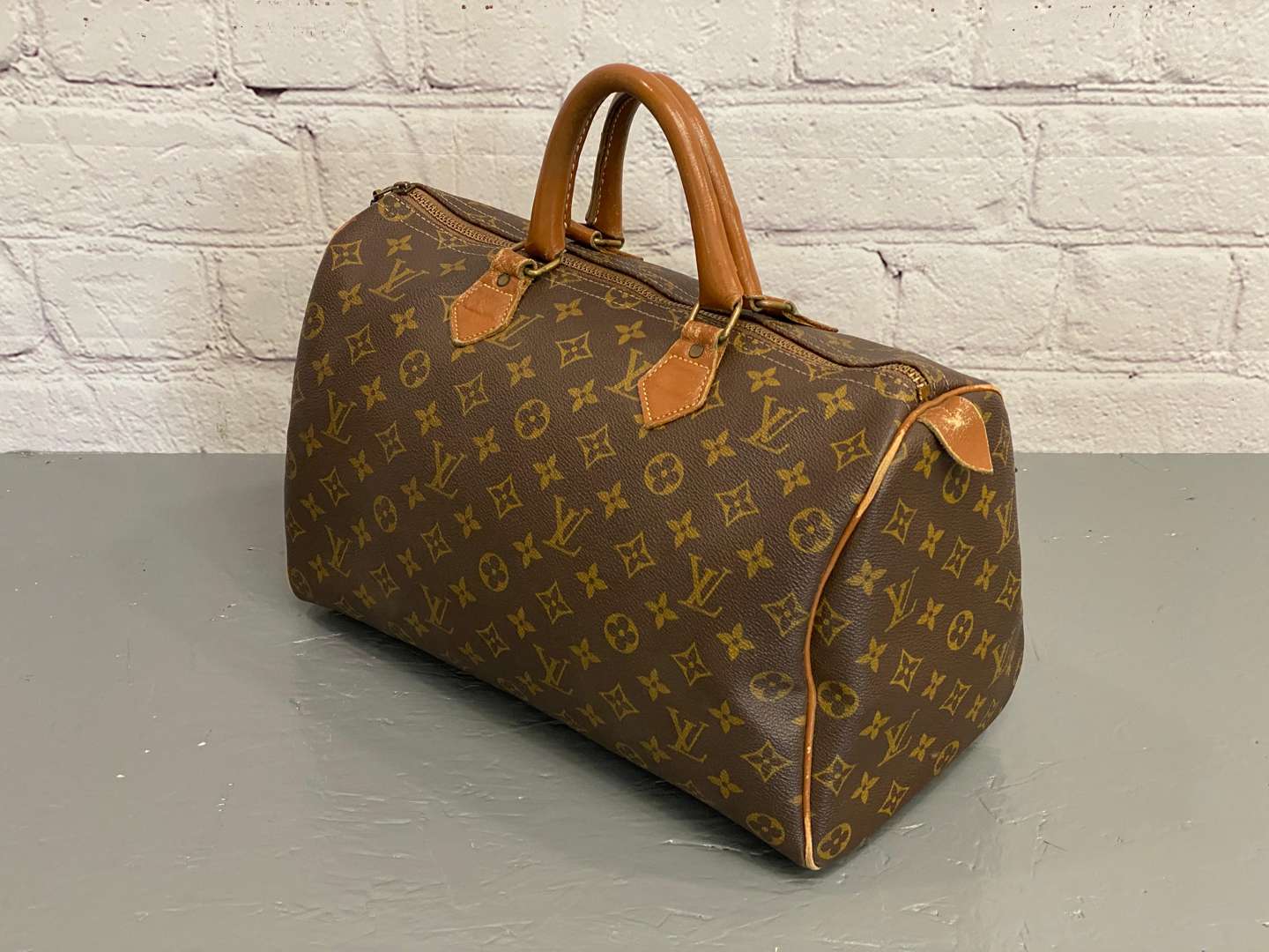 <p>LOUIS VUITTON, Speedy 35, monogram canvas and stitched leather holdall,</p>
