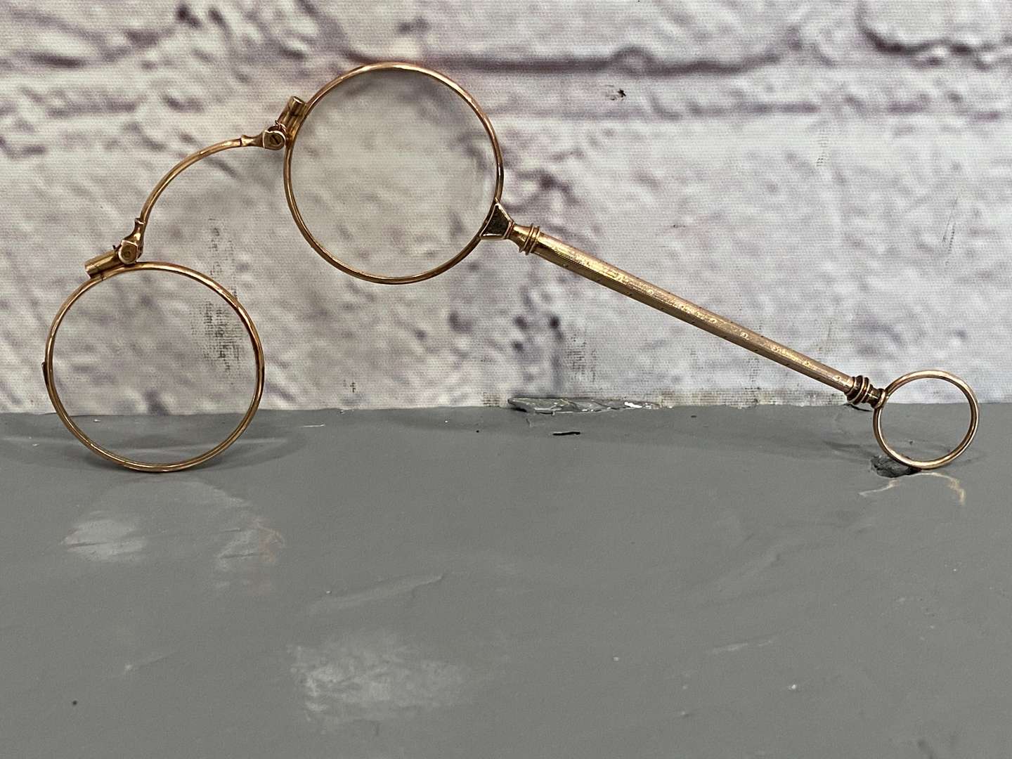 <p>A pair of late 19th century Continental, gold, &nbsp;folding Lorgnettes,</p>