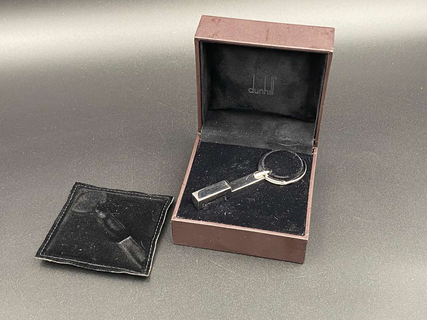 <p>DUNHILL, a modern silver and chrome metal keyring,</p>