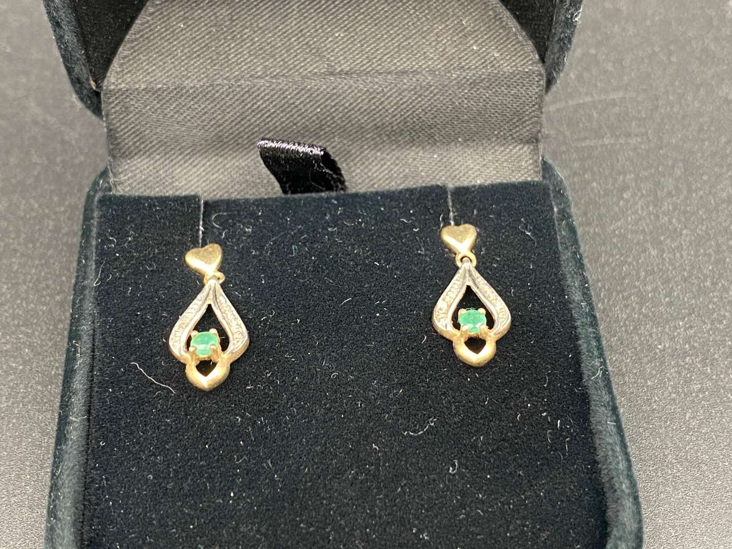 <p>Pair of yellow metal and emerald earrings</p>