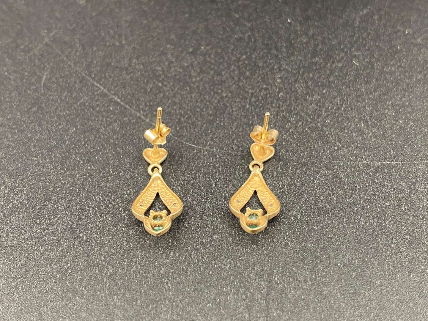 <p>Pair of yellow metal and emerald earrings</p>