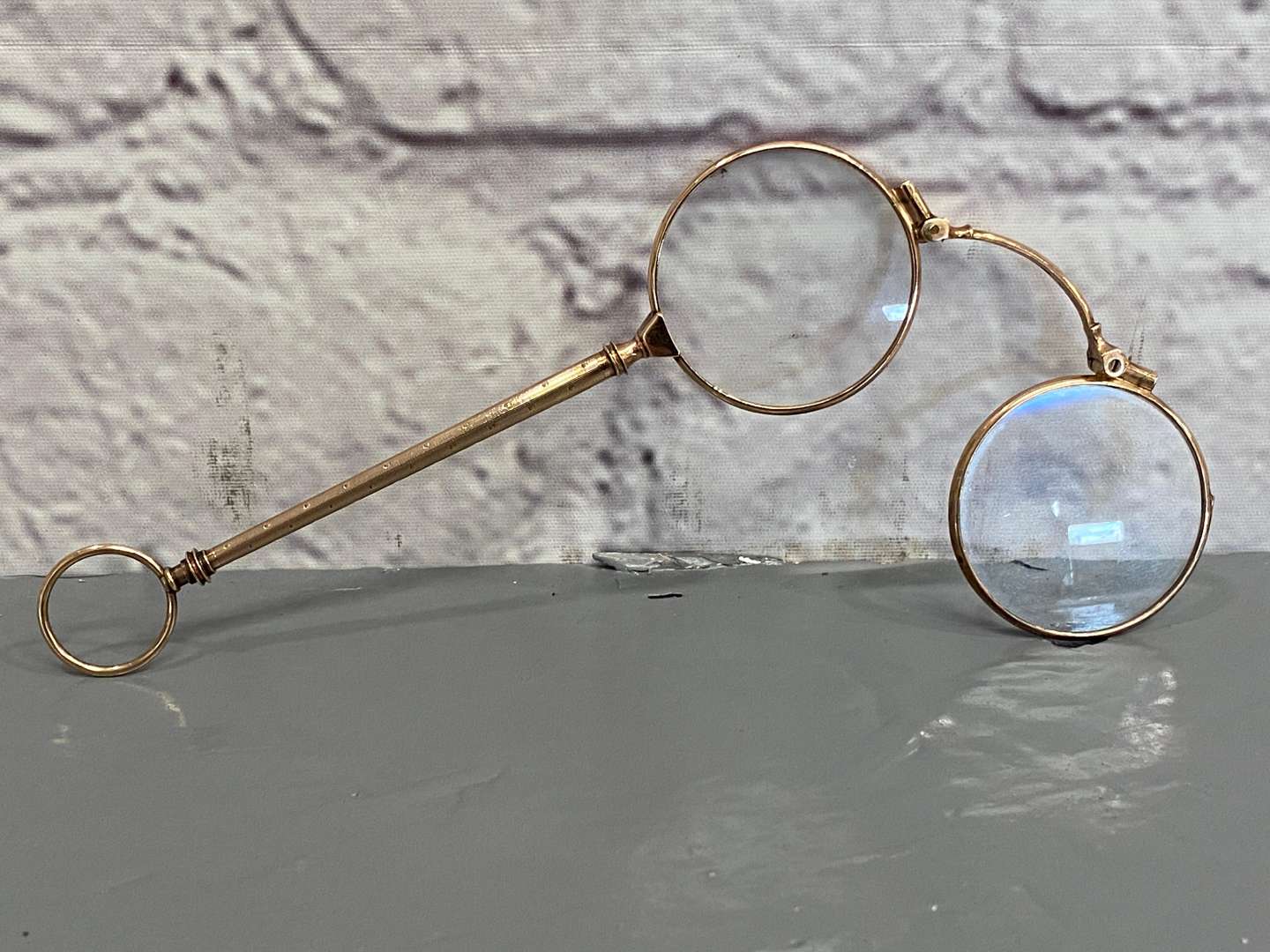 <p>A pair of late 19th century Continental, gold, &nbsp;folding Lorgnettes,</p>