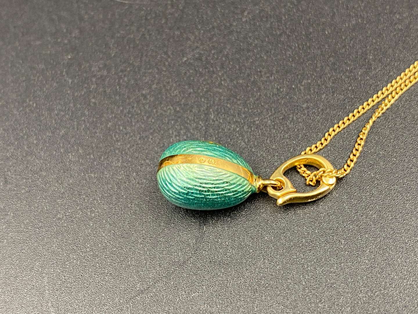 <p>FABERGE, a .750 and enamel Egg pendant, 241/500</p>