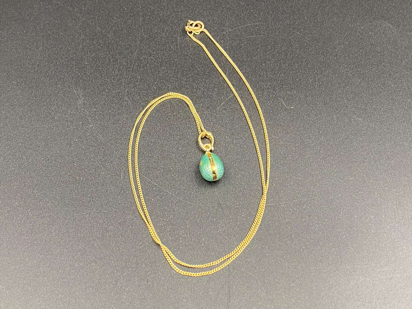 <p>FABERGE, a .750 and enamel Egg pendant, 241/500</p>