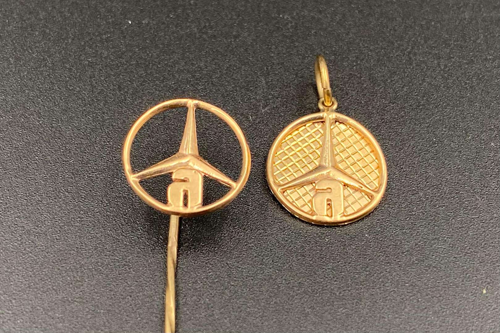 <p>MERCEDES-BENZ, unmarked yellow metal fob pendant and tiepin</p>