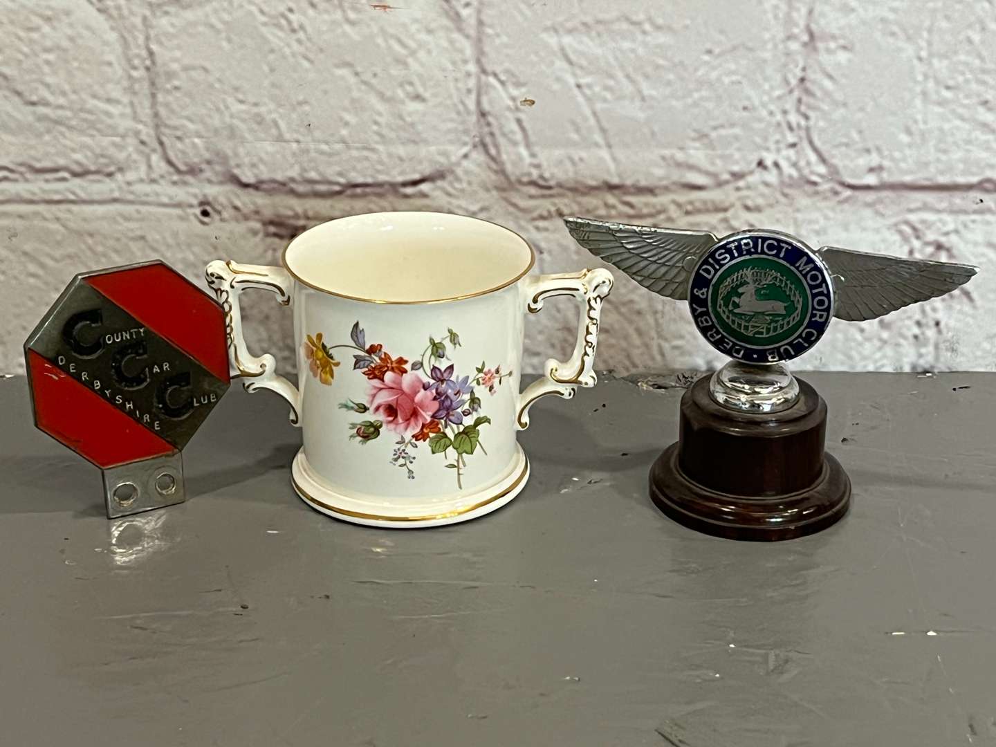 <p>Derby District Motor Club Mascot, Badge and Crown Derby Two Handled Mug (3)</p>