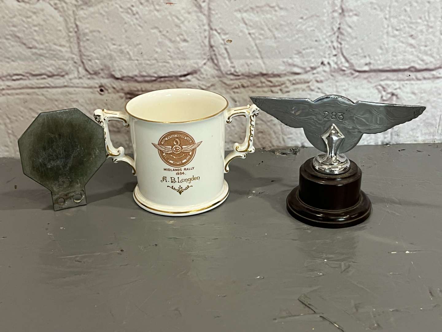 <p>Derby District Motor Club Mascot, Badge and Crown Derby Two Handled Mug (3)</p>