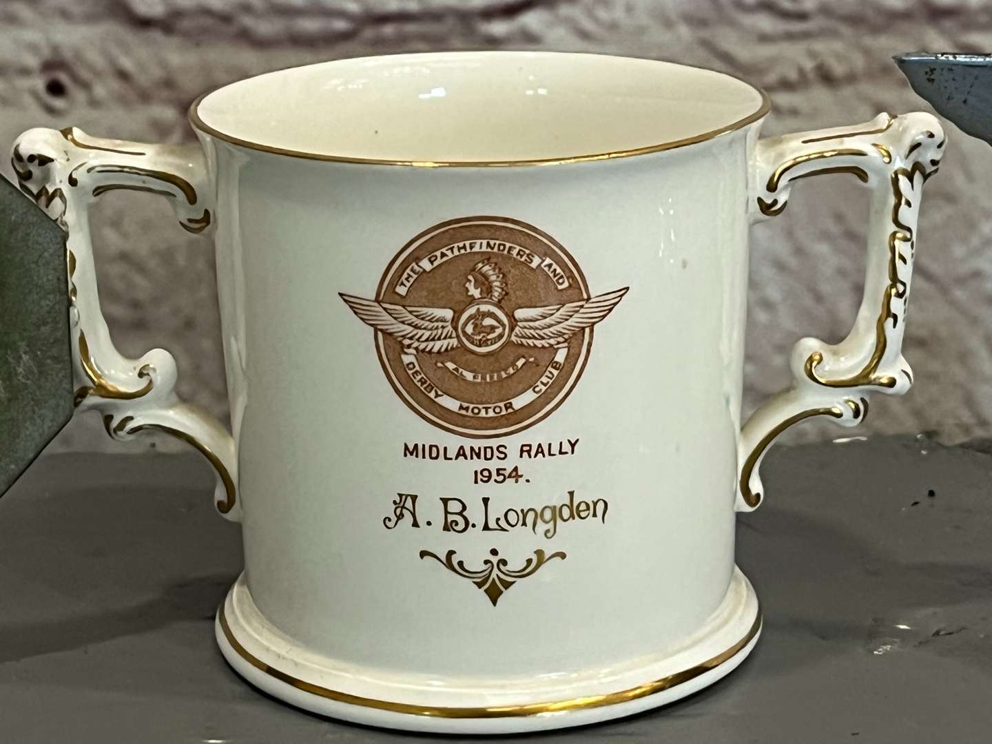 <p>Derby District Motor Club Mascot, Badge and Crown Derby Two Handled Mug (3)</p>