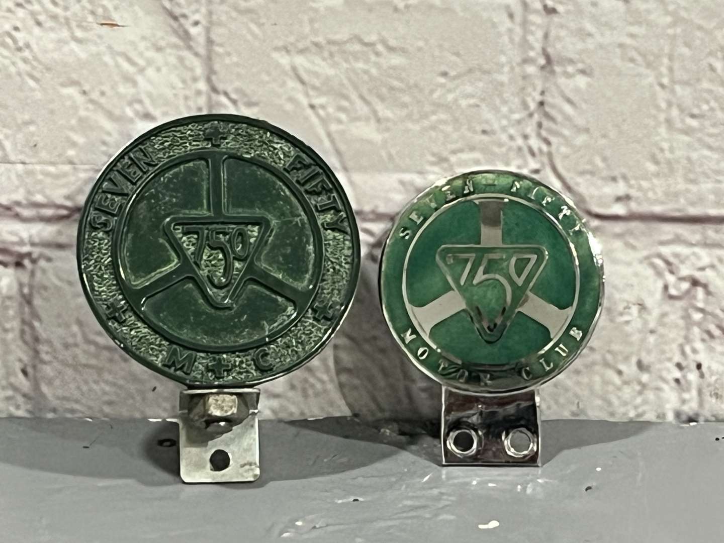<p>Two 750 Motor Club Car Badges&nbsp;</p>