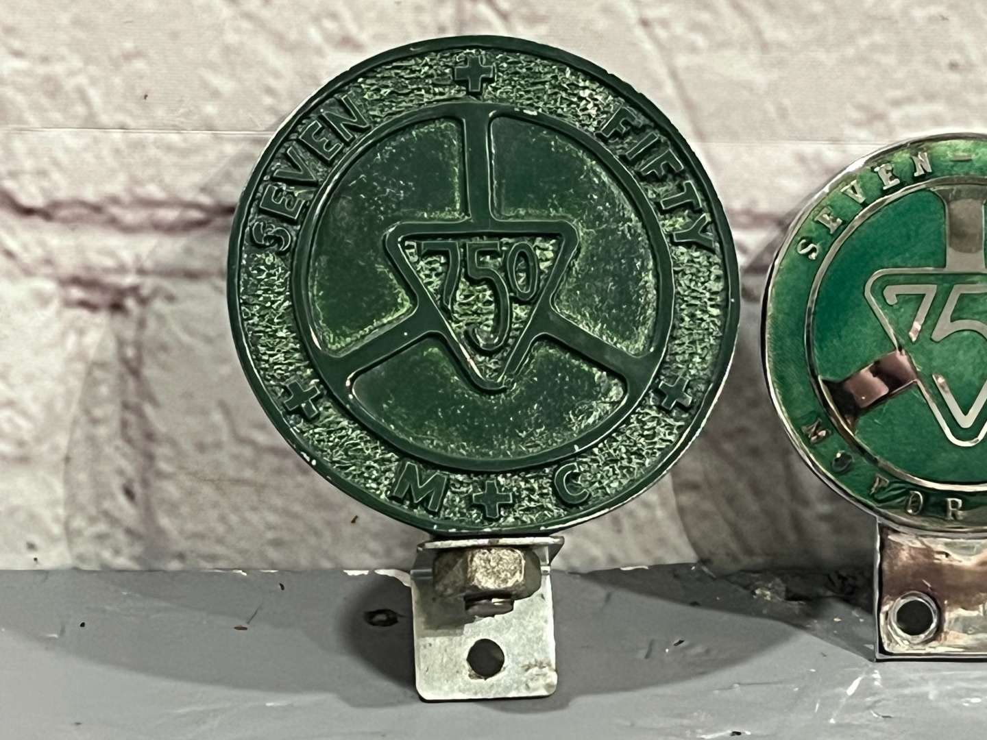 <p>Two 750 Motor Club Car Badges&nbsp;</p>