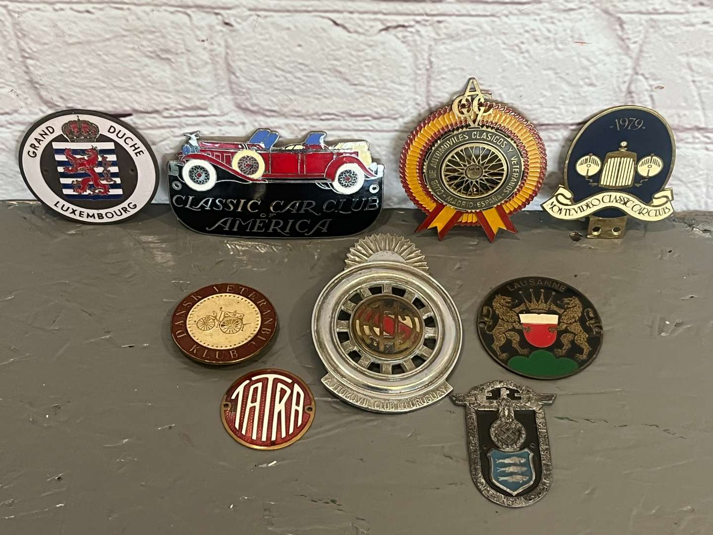 <p>Nine Enamel Classic Car Badges&nbsp;</p>