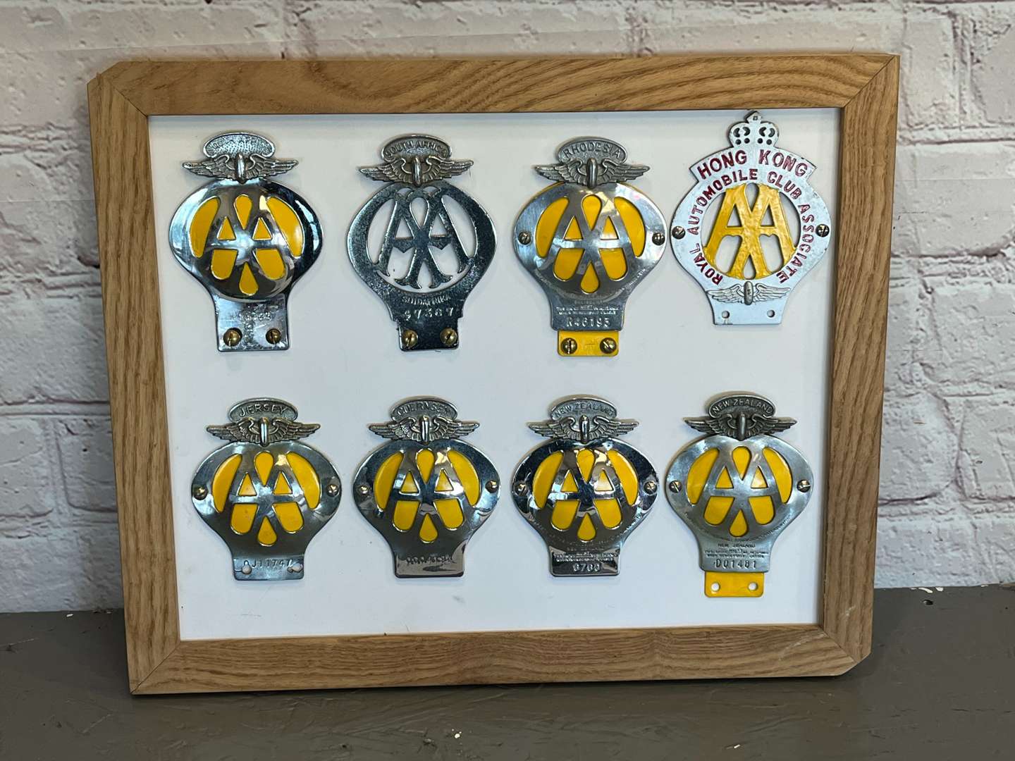 <p>Eight Framed AA Badges&nbsp;</p>