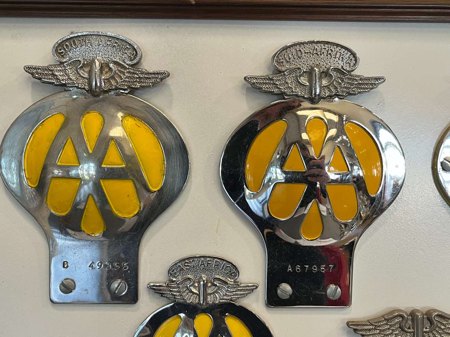 <p>Sixteen Framed Classic Car Badges&nbsp;</p>