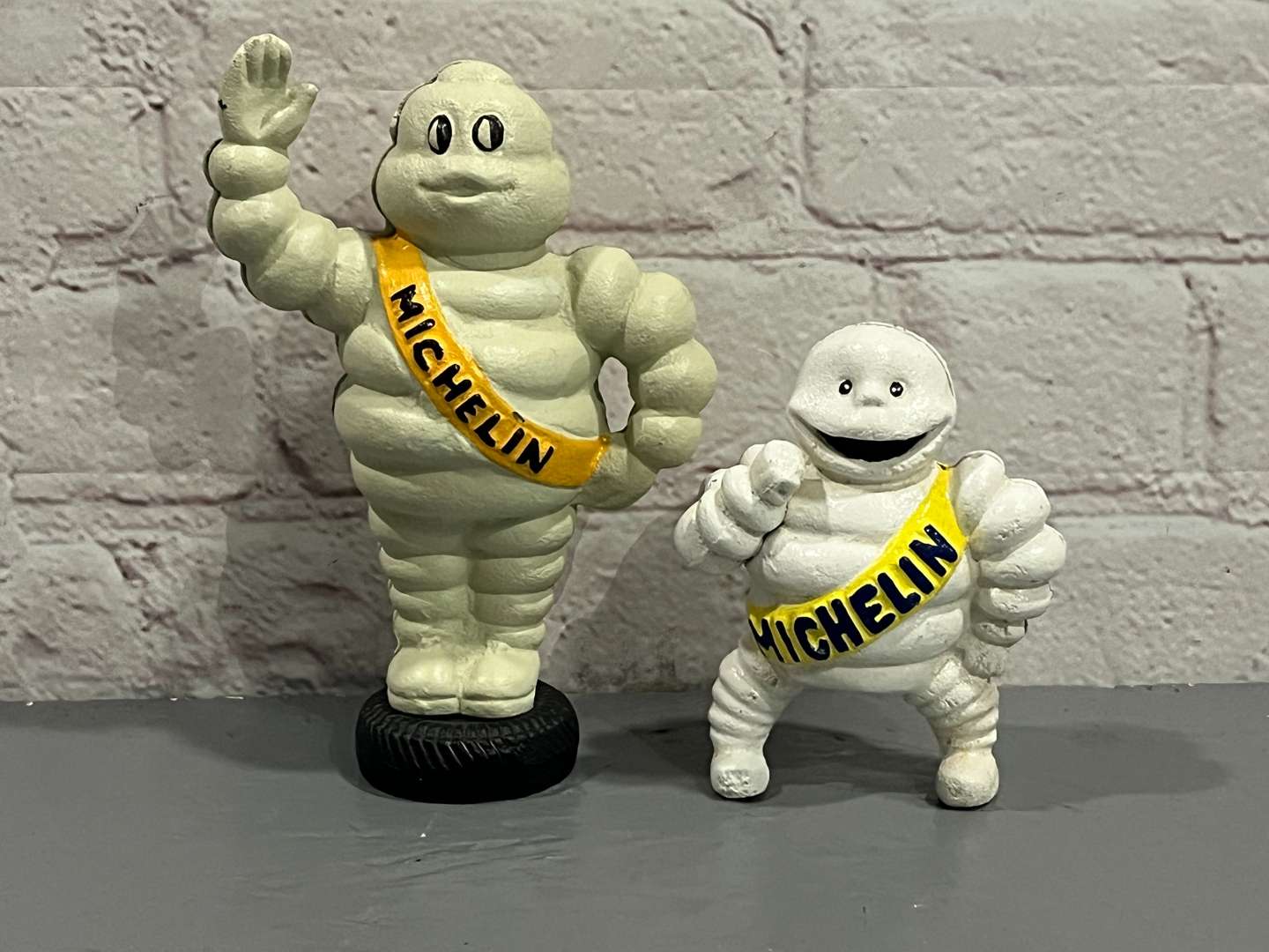 <p>Two Cast Iron Michelin Figures</p>