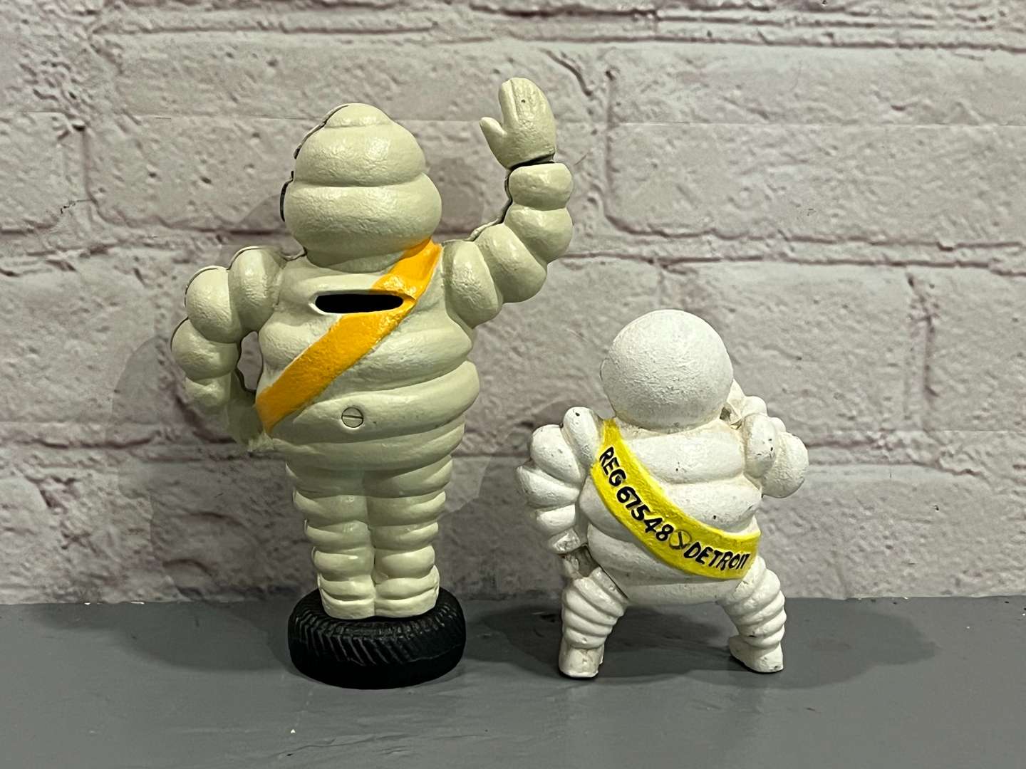 <p>Two Cast Iron Michelin Figures</p>
