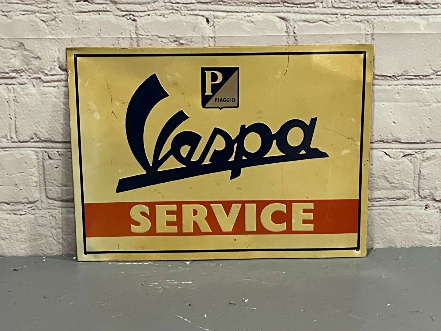 <p>Vespa Service Pressed Tin Sign</p>