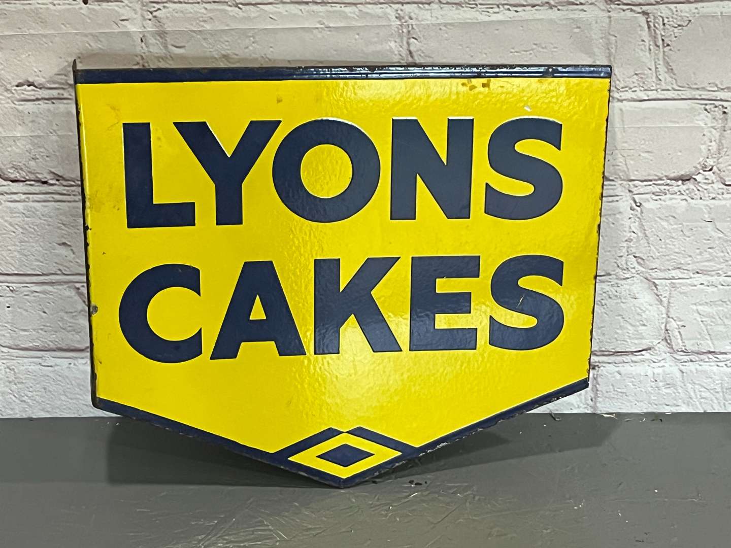 <p>Lyons Cakes Enamel Flange Sign</p>