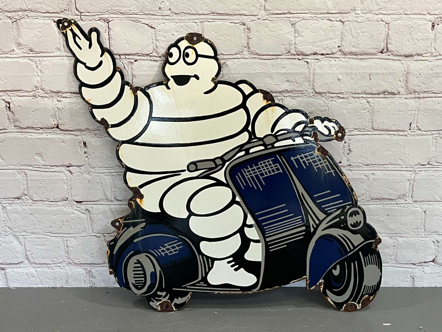 <p>Michelin Man on a Scooter Enamel Sign&nbsp;</p>