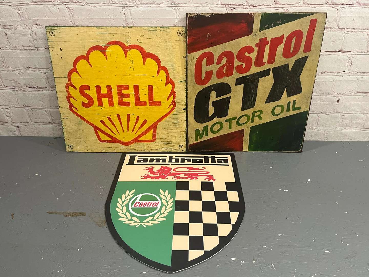 <p>Castrol and Shell Painted Wooden Sign and One Lambretta Sign (3)</p>