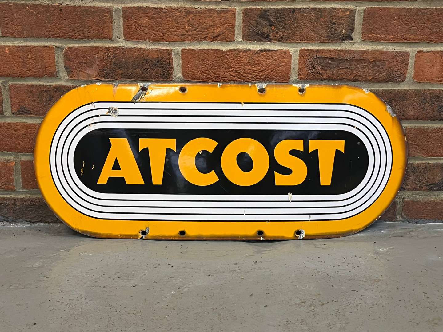 <p>Atcost Enamel Sign</p>