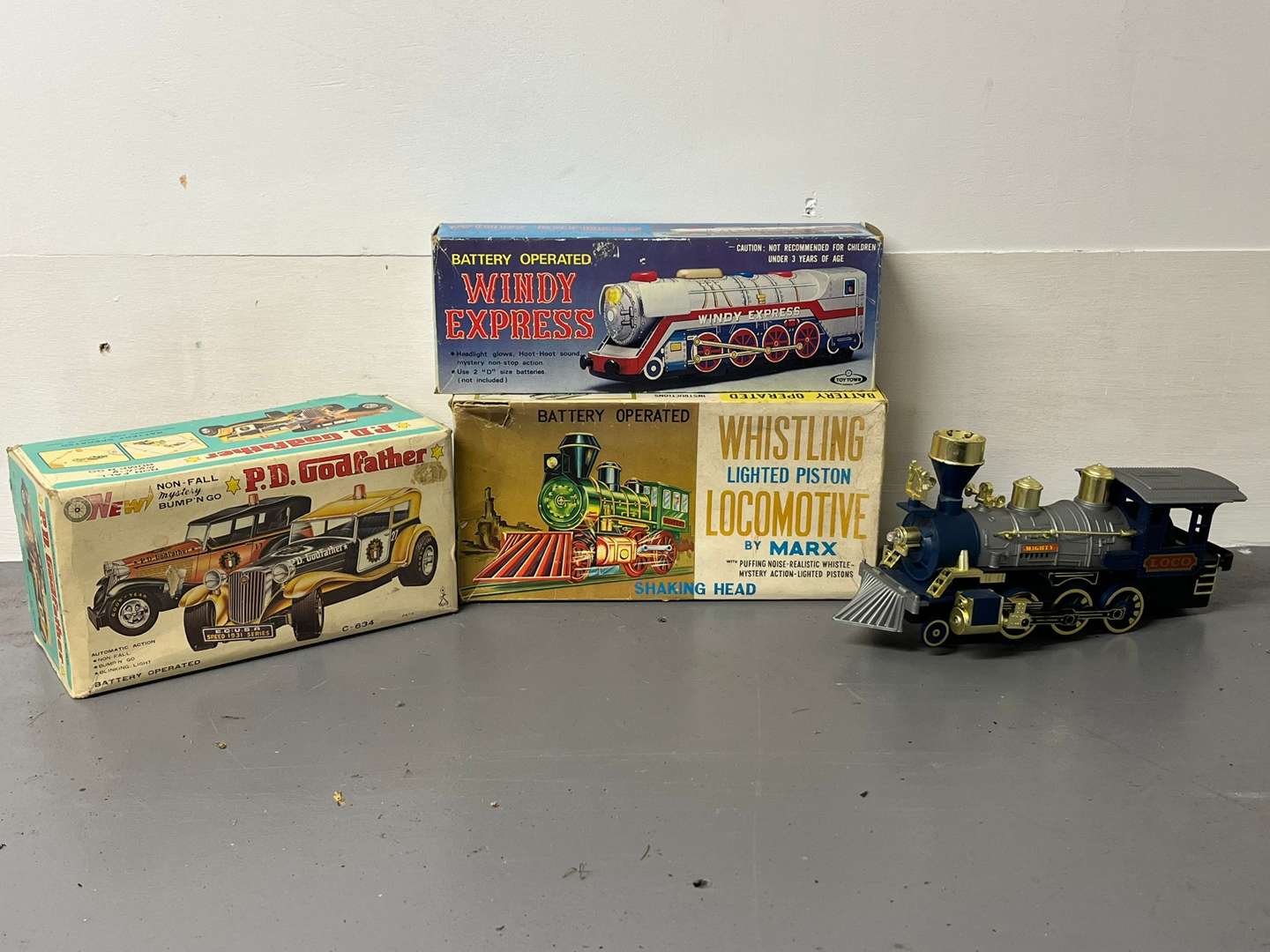 <p>Four Toy Trains and Car, Three in Original Boxes</p>