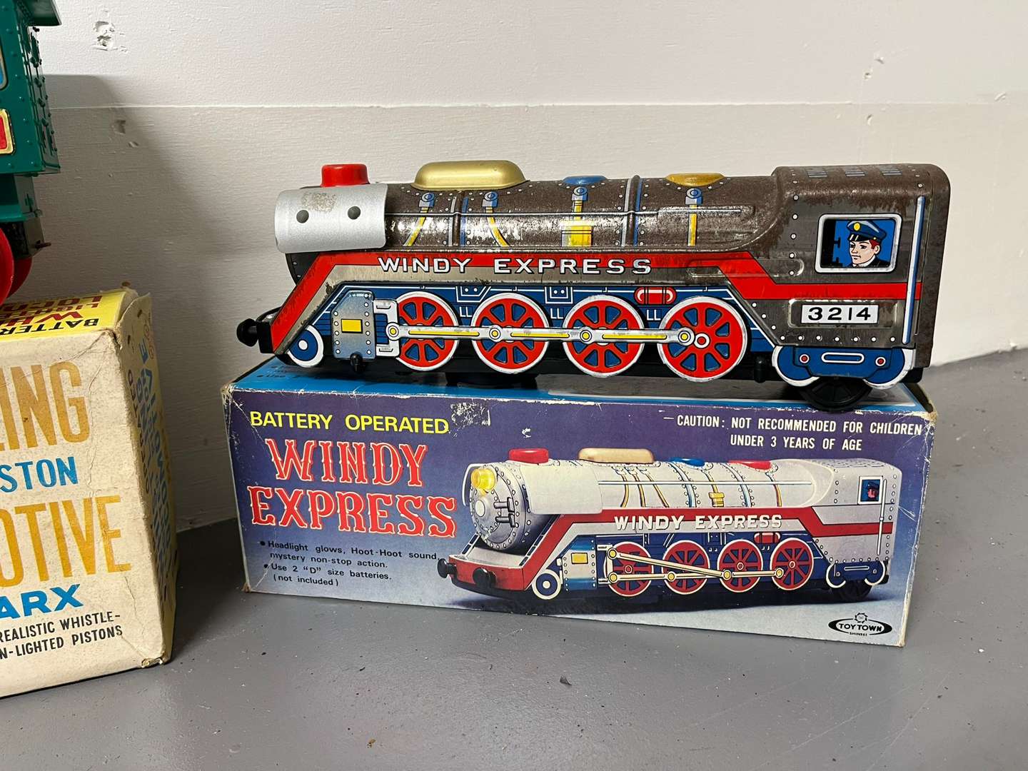 <p>Four Toy Trains and Car, Three in Original Boxes</p>