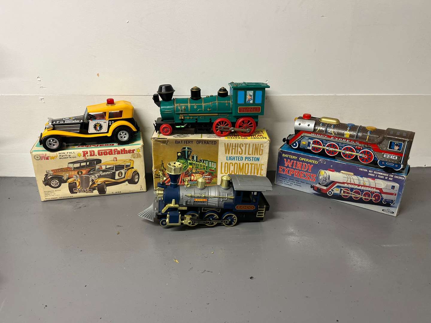 <p>Four Toy Trains and Car, Three in Original Boxes</p>