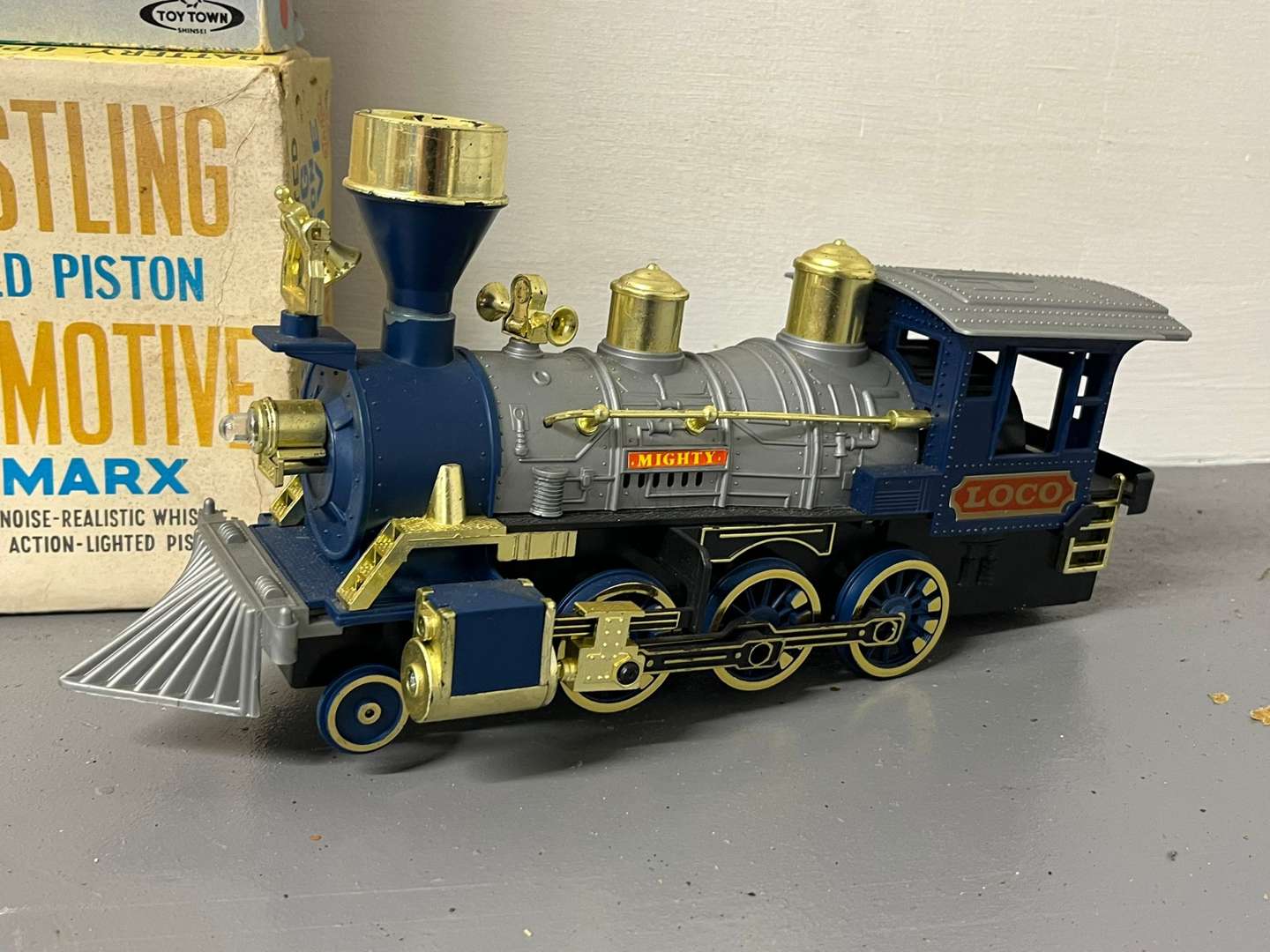 <p>Four Toy Trains and Car, Three in Original Boxes</p>