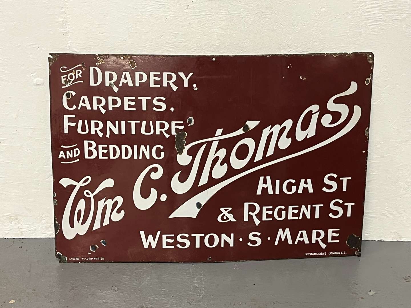 <p>Wm C. Thomas Drapery Enamel Sign</p>