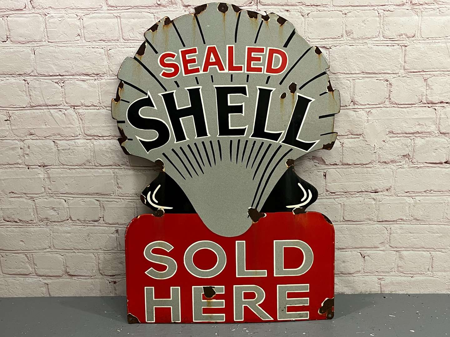 <p>Sealed Shell Sold Here Enamel Sign</p>