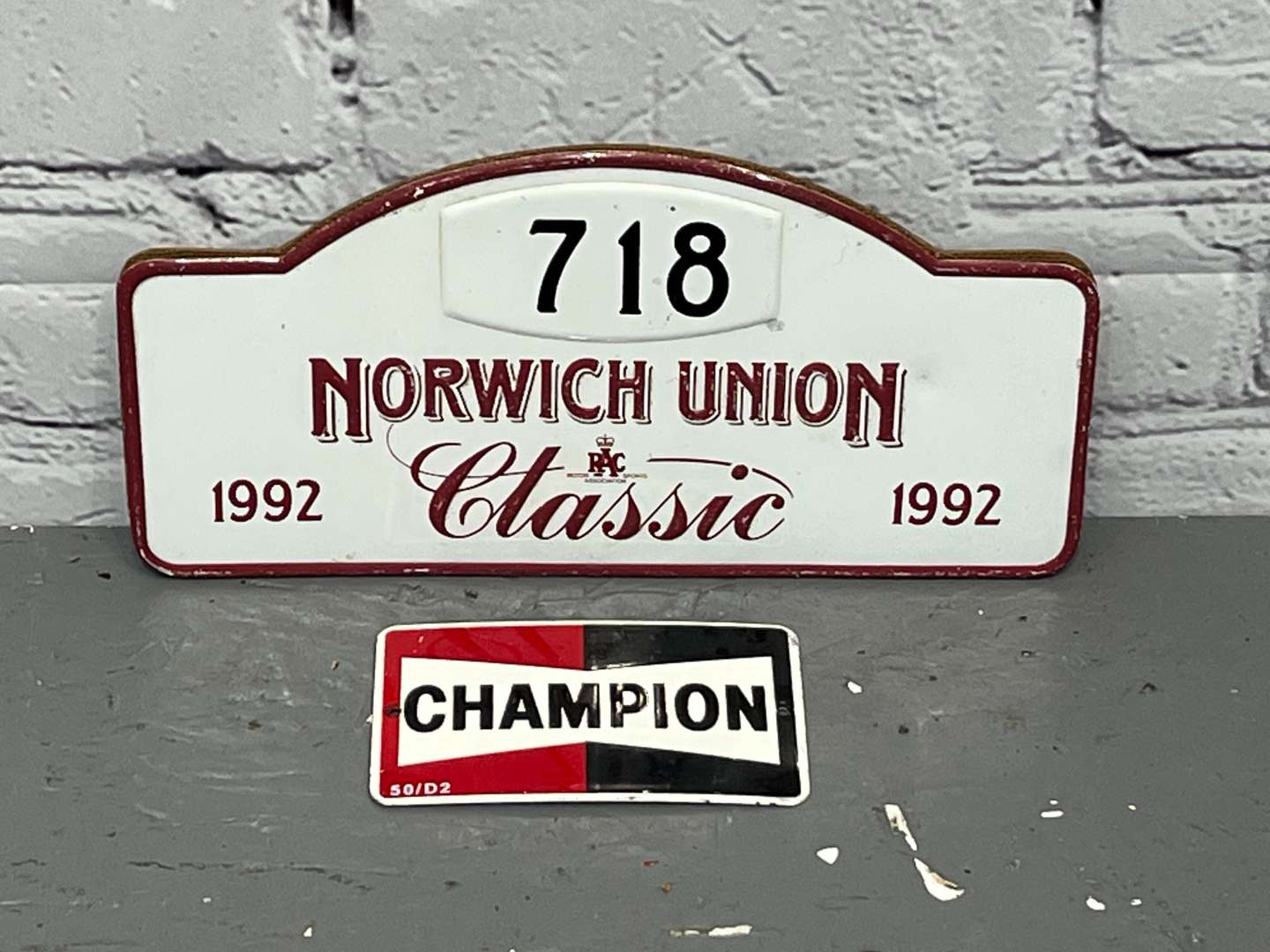 <p>Champion Small Enamel Sign & Norwich Union Rally Plaque (2)</p>