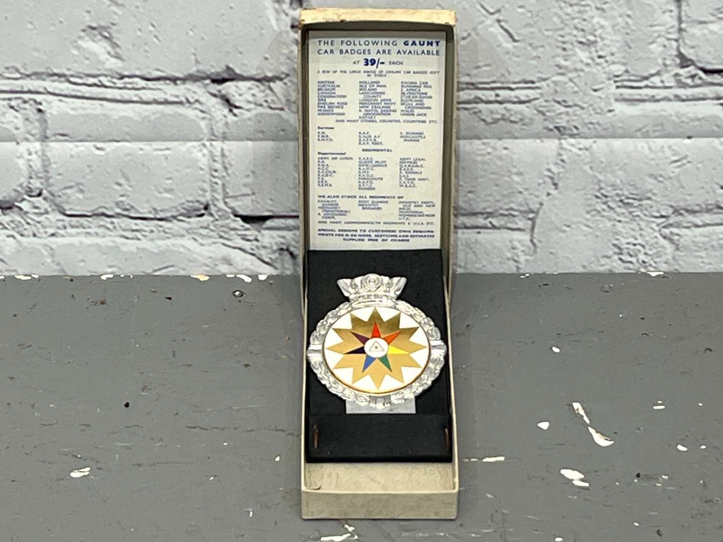 <p>JR Gaunt Rare Multicolour Twelve Point Star Car Badge Boxed</p>