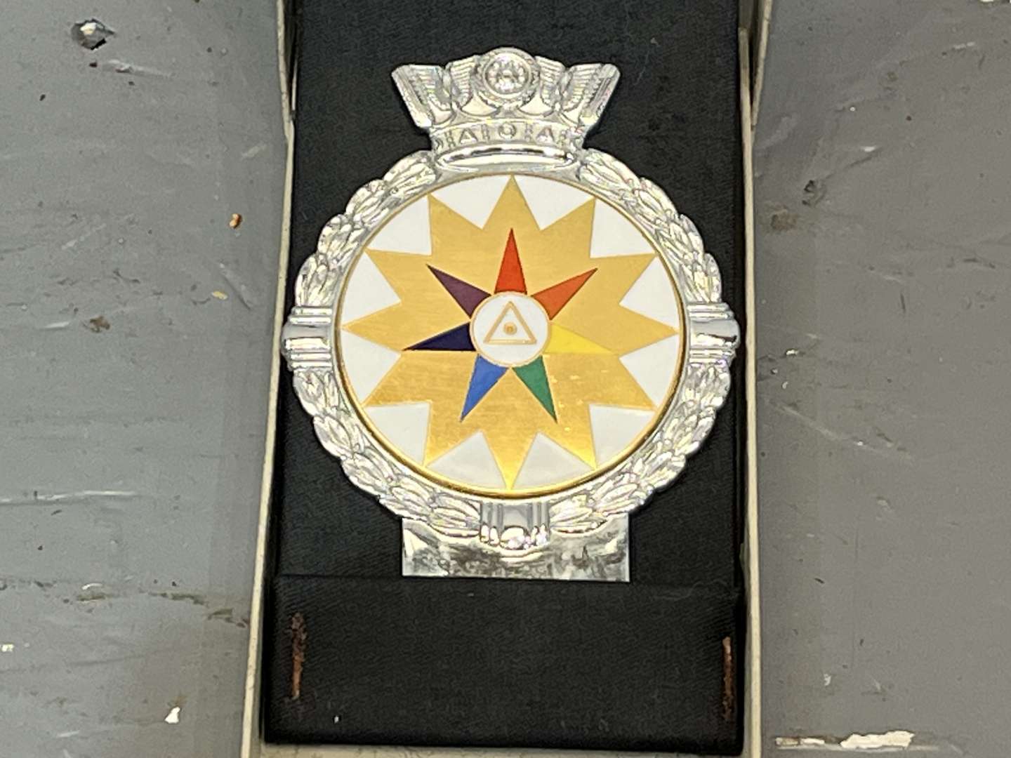 <p>JR Gaunt Rare Multicolour Twelve Point Star Car Badge Boxed</p>